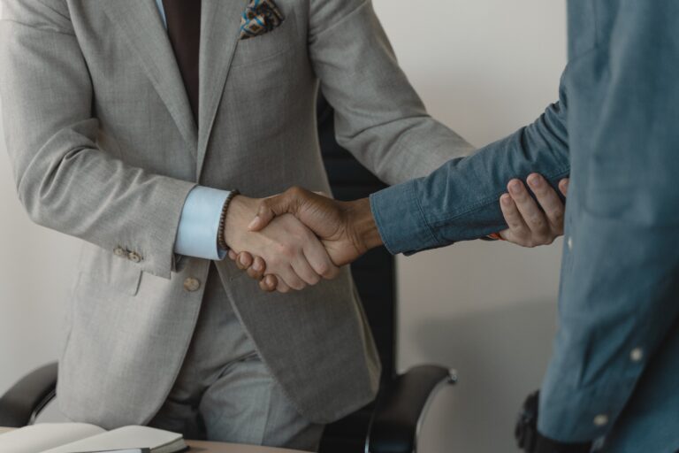 two men shaking hands at a job interview