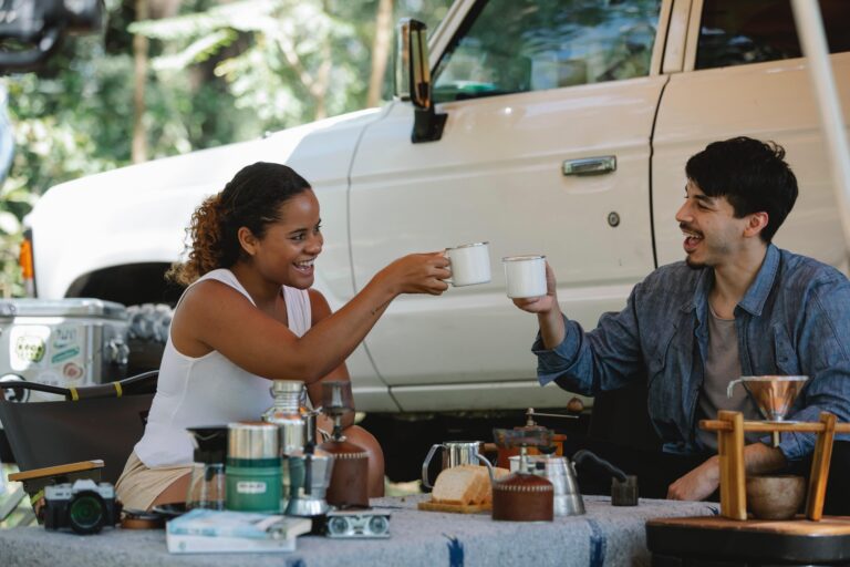 a picture of a woman and a man camping and drinking tea
