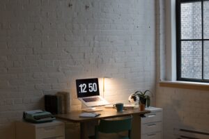 at home office with brick wall and low lamp